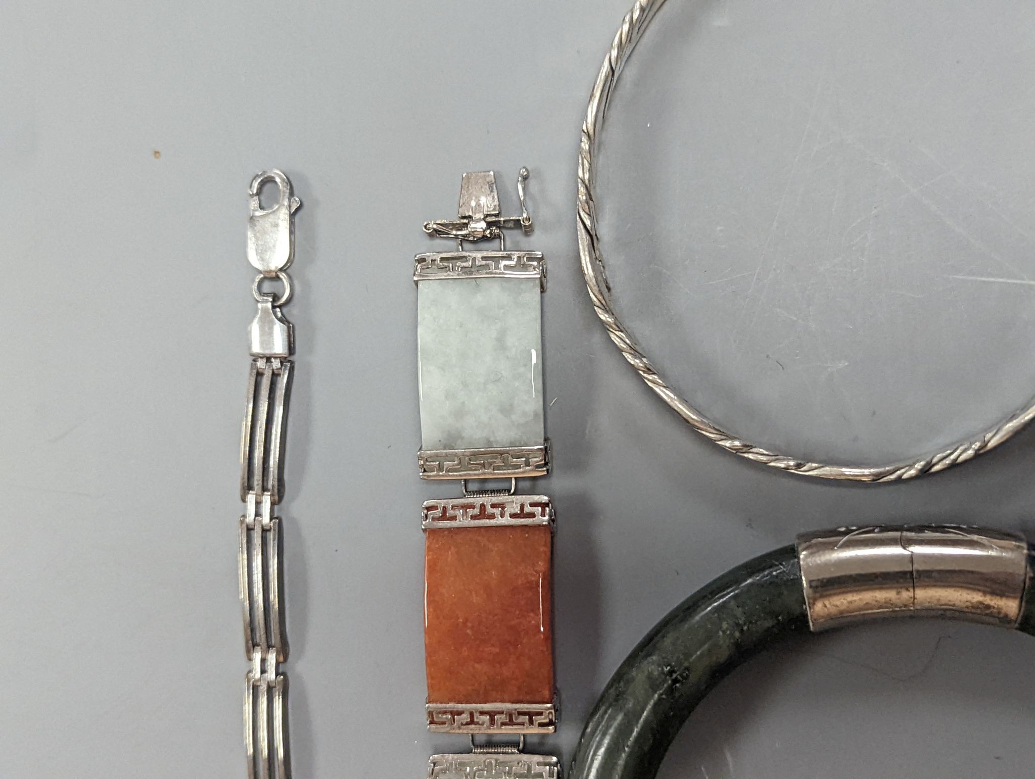 A 925 and hardstone set bracelet, 19.7cm, one other bracelet, two cameo shell brooches, three assorted bangles and a pair of sugar tongs.